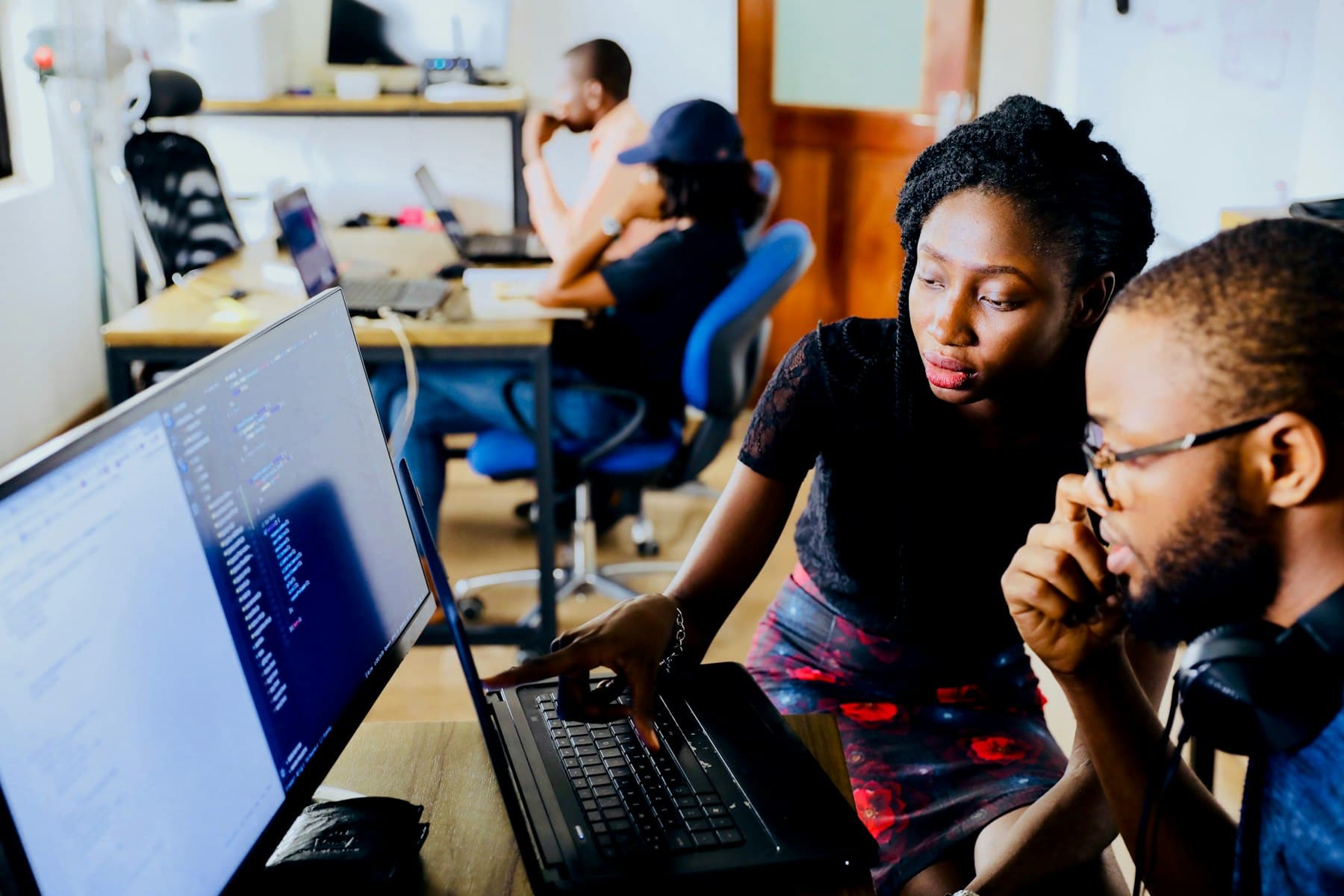 Two engineers reviewing code together on screen in a shared workspace