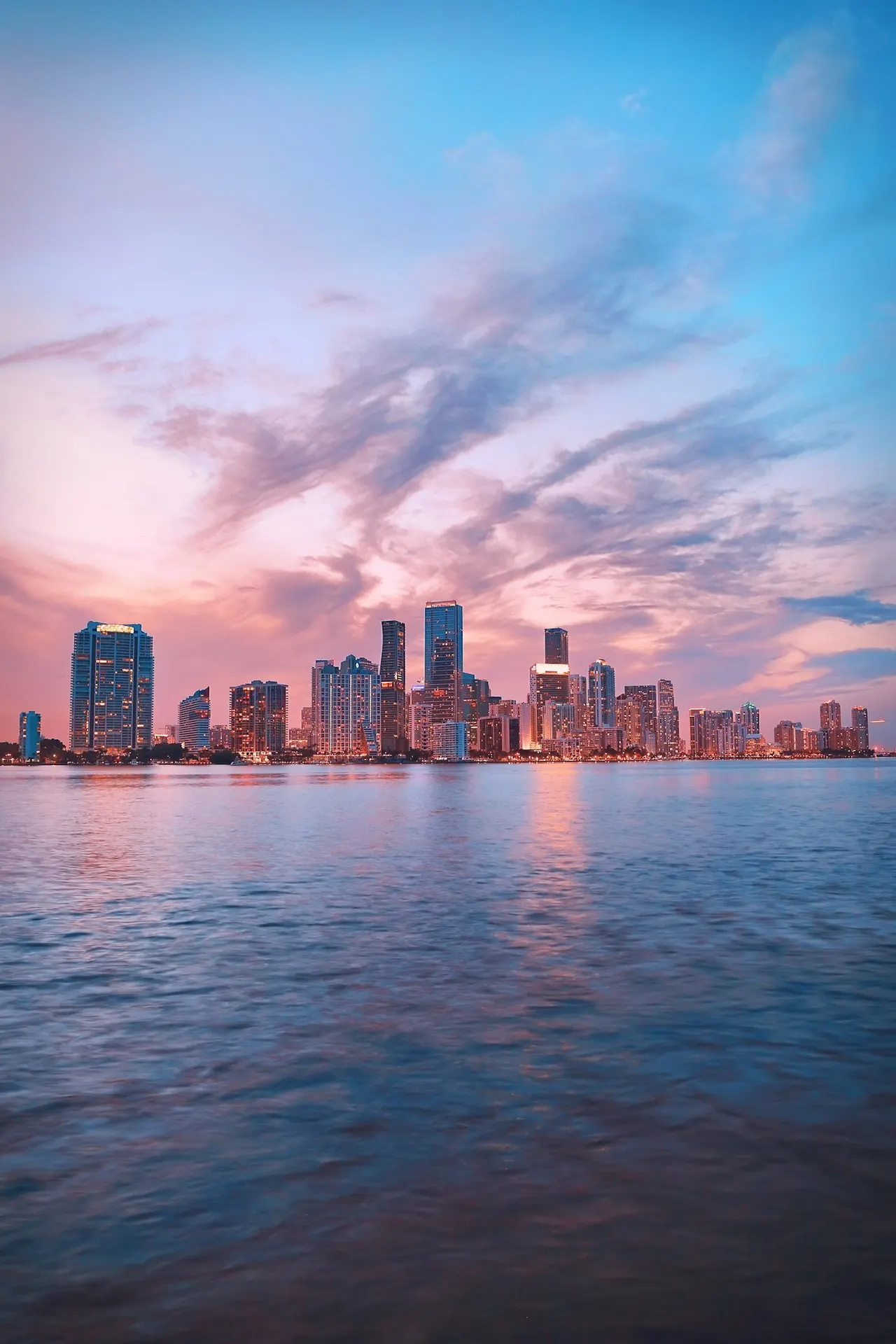 The Miami skyline at sunset seen across Biscayne Bay