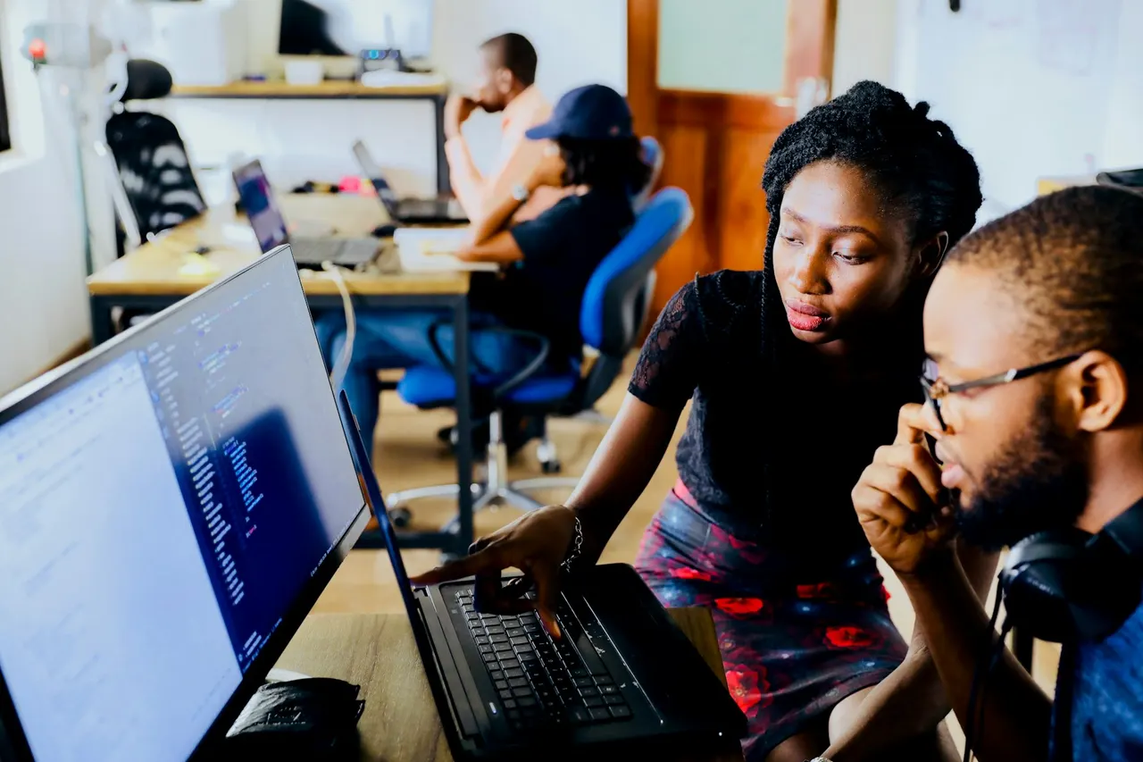 Two engineers reviewing code together on screen in a shared workspace